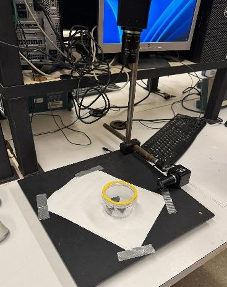 Final yellow-tape lid marker on the inspection station